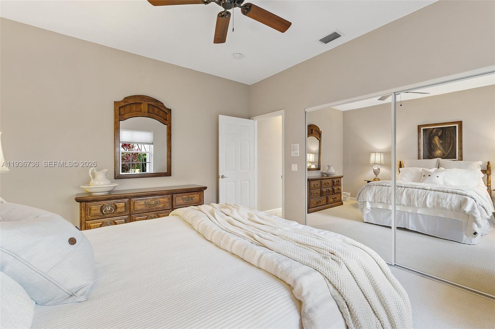 8185 Southeast Double Tree Drive Hobe Sound, FL 33455 - Photo 26 of 40 a bedroom with a bed and a dresser