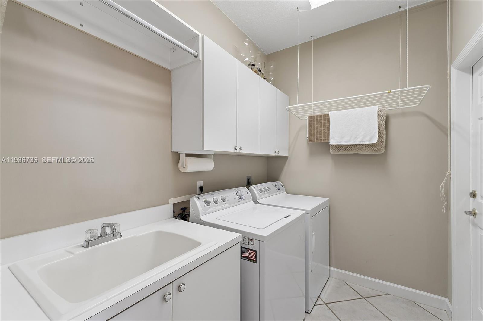 8185 Southeast Double Tree Drive Hobe Sound, FL 33455 - Photo 29 of 40 a utility room with dryer and washer