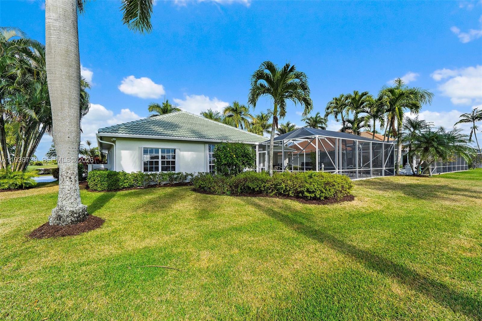 8185 Southeast Double Tree Drive Hobe Sound, FL 33455 - Photo 32 of 40 a front view of a house with a yard