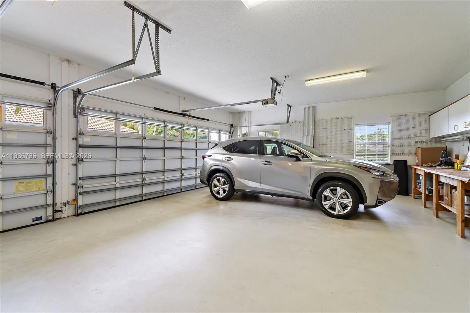 8185 Southeast Double Tree Drive Hobe Sound, FL 33455 - Photo 34 of 40 a view of a garage and car parked