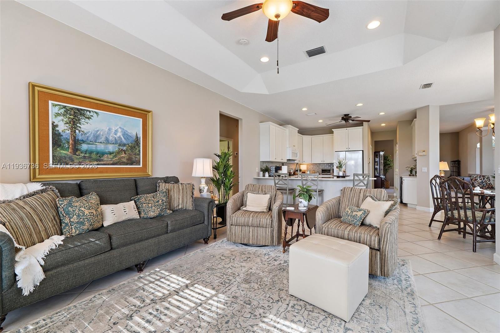 8185 Southeast Double Tree Drive Hobe Sound, FL 33455 - Photo 7 of 40 a living room with furniture kitchen view and a chandelier