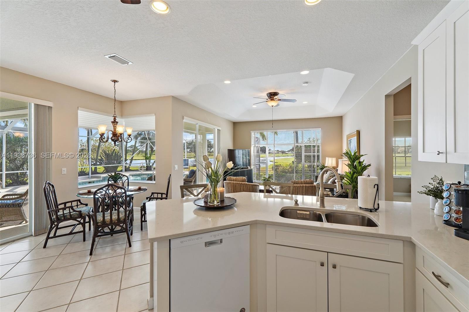 8185 Southeast Double Tree Drive Hobe Sound, FL 33455 - Photo 10 of 40 a kitchen with sink and view of living room