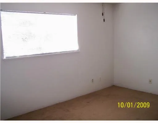 a bathroom with a granite countertop sink a toilet and a shower