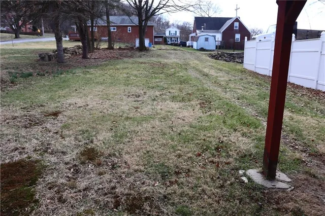 a view of a yard with a tree