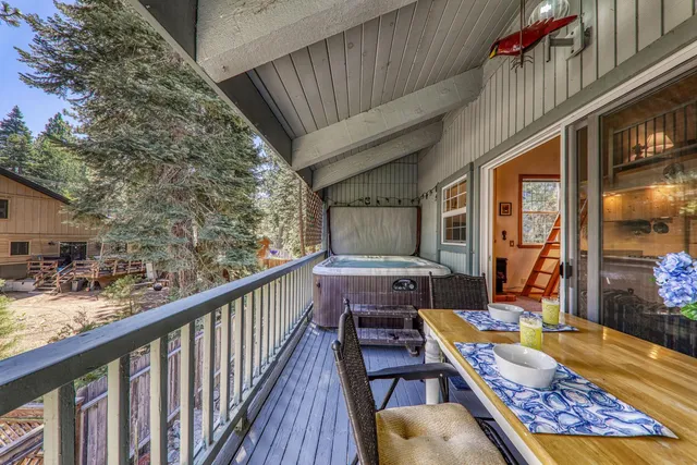 a view of a house with backyard porch and wooden fence