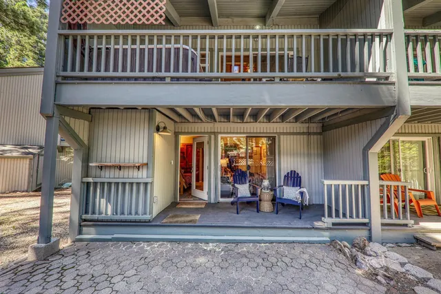 a view of a house with backyard and sitting area