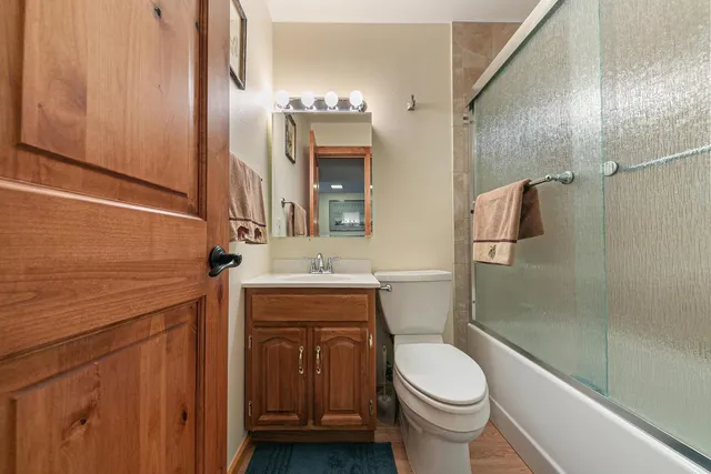 a bathroom with a sink a toilet and shower