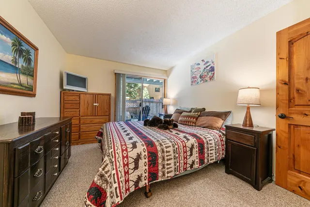 a bedroom with a bed and a dresser in it