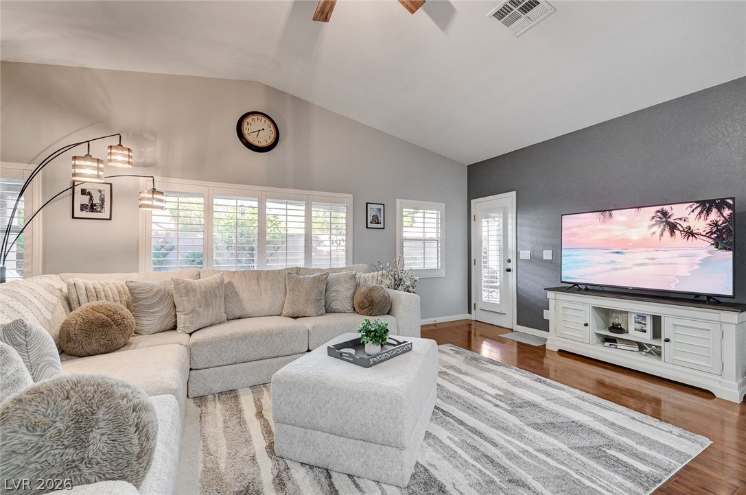 1604 Cattle Ranch Place Henderson, NV 89002 - Photo 25 of 99 A relaxed living space with warm wood floors and ample natural light, ideal for unwinding.