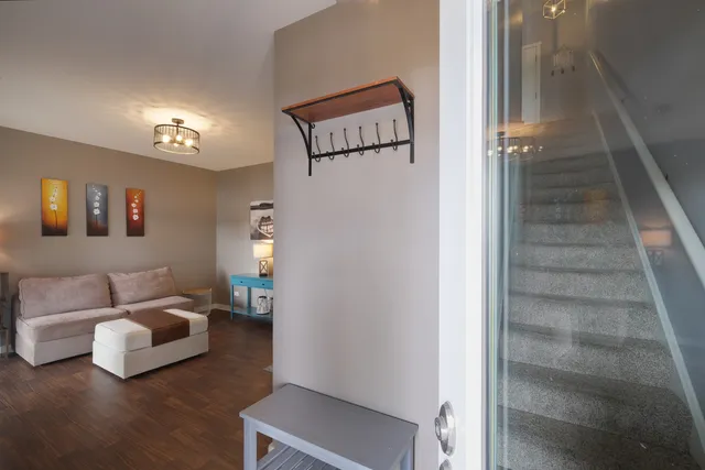 a living room with furniture and a stairs