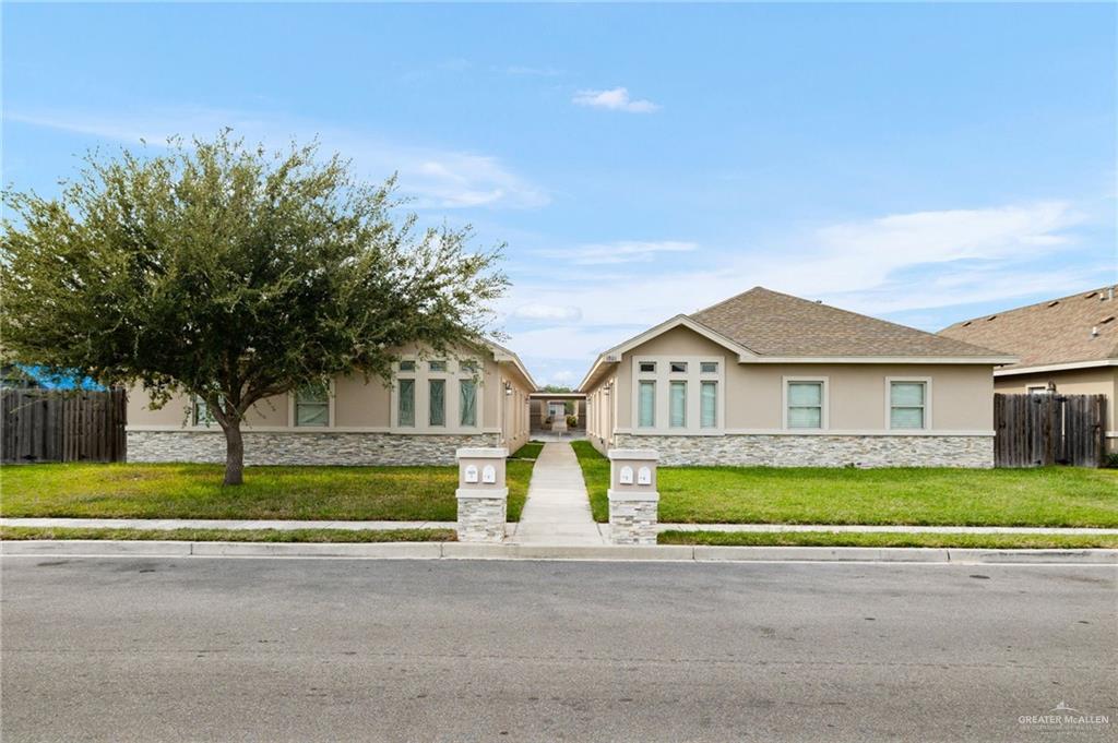 1801 Jackson Street Weslaco, TX 78599 - Photo 1 of 15 a view of house with a big yard and large trees