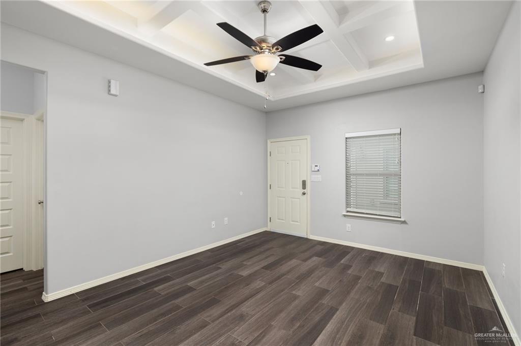 1801 Jackson Street Weslaco, TX 78599 - Photo 2 of 15 an empty room with wooden floor and ceiling fan