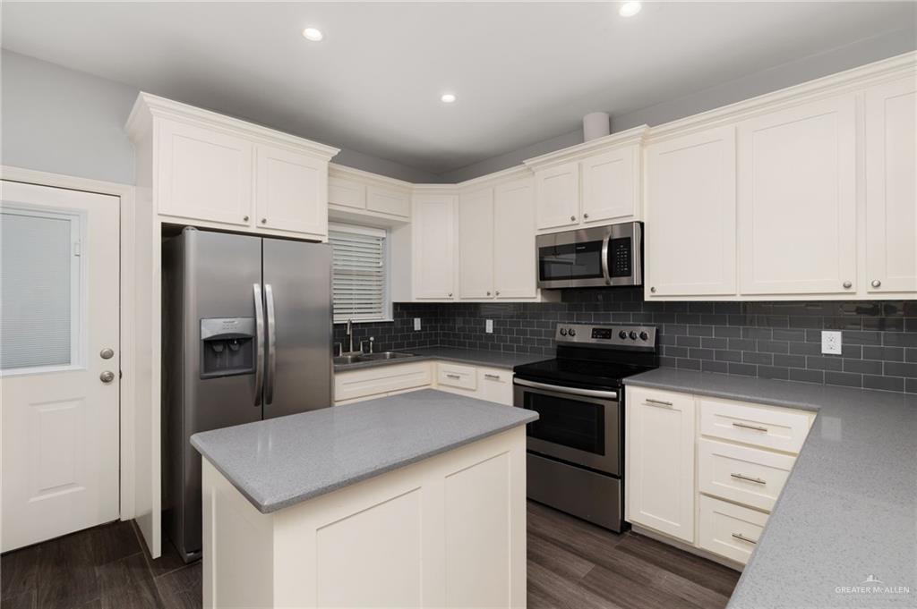 1801 Jackson Street Weslaco, TX 78599 - Photo 4 of 15 a kitchen with a refrigerator stove and microwave