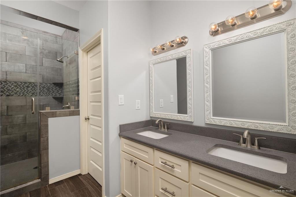 1801 Jackson Street Weslaco, TX 78599 - Photo 6 of 15 a bathroom with a double vanity sink mirror and shower