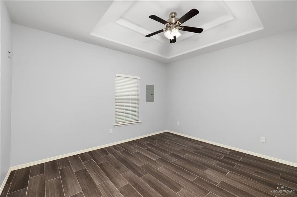 1801 Jackson Street Weslaco, TX 78599 - Photo 7 of 15 an empty room with wooden floor and windows