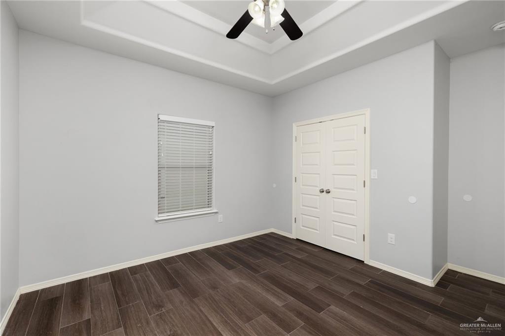 1801 Jackson Street Weslaco, TX 78599 - Photo 8 of 15 an empty room with wooden floor cabinet and windows