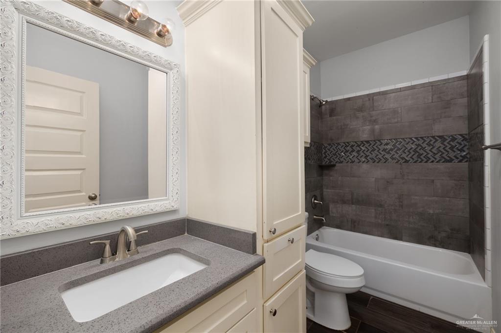 1801 Jackson Street Weslaco, TX 78599 - Photo 9 of 15 a bathroom with a sink a toilet and a bathtub
