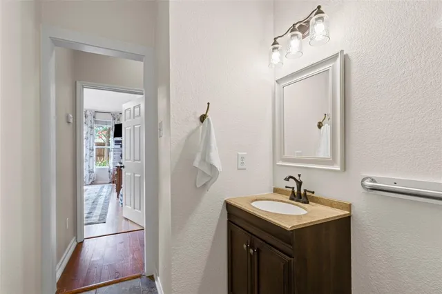 a bathroom with a sink a light fixture and a mirror