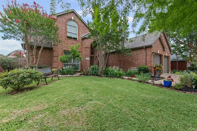 a front view of a house with a garden and plants
