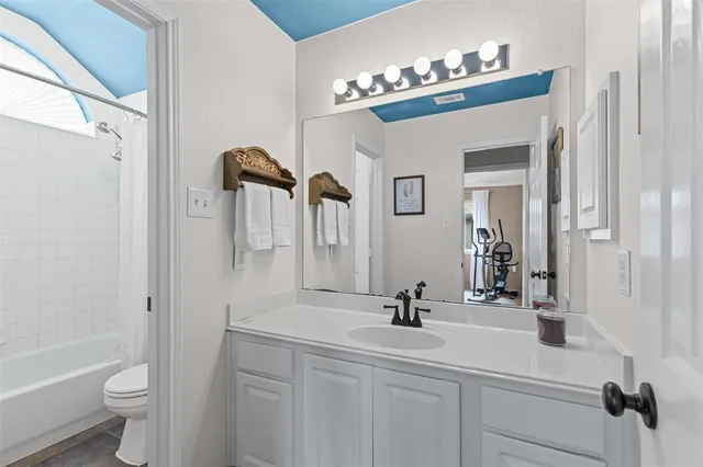 a bathroom with a double vanity sink toilet and shower