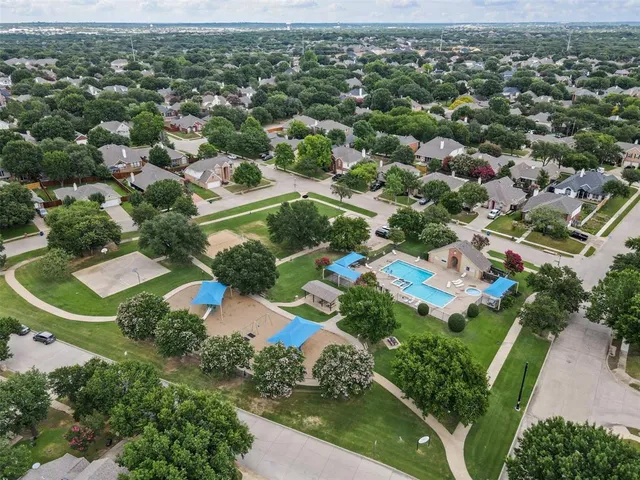 an aerial view of residential houses with outdoor space and street view