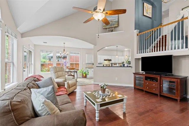 a living room with furniture a flat screen tv and a window