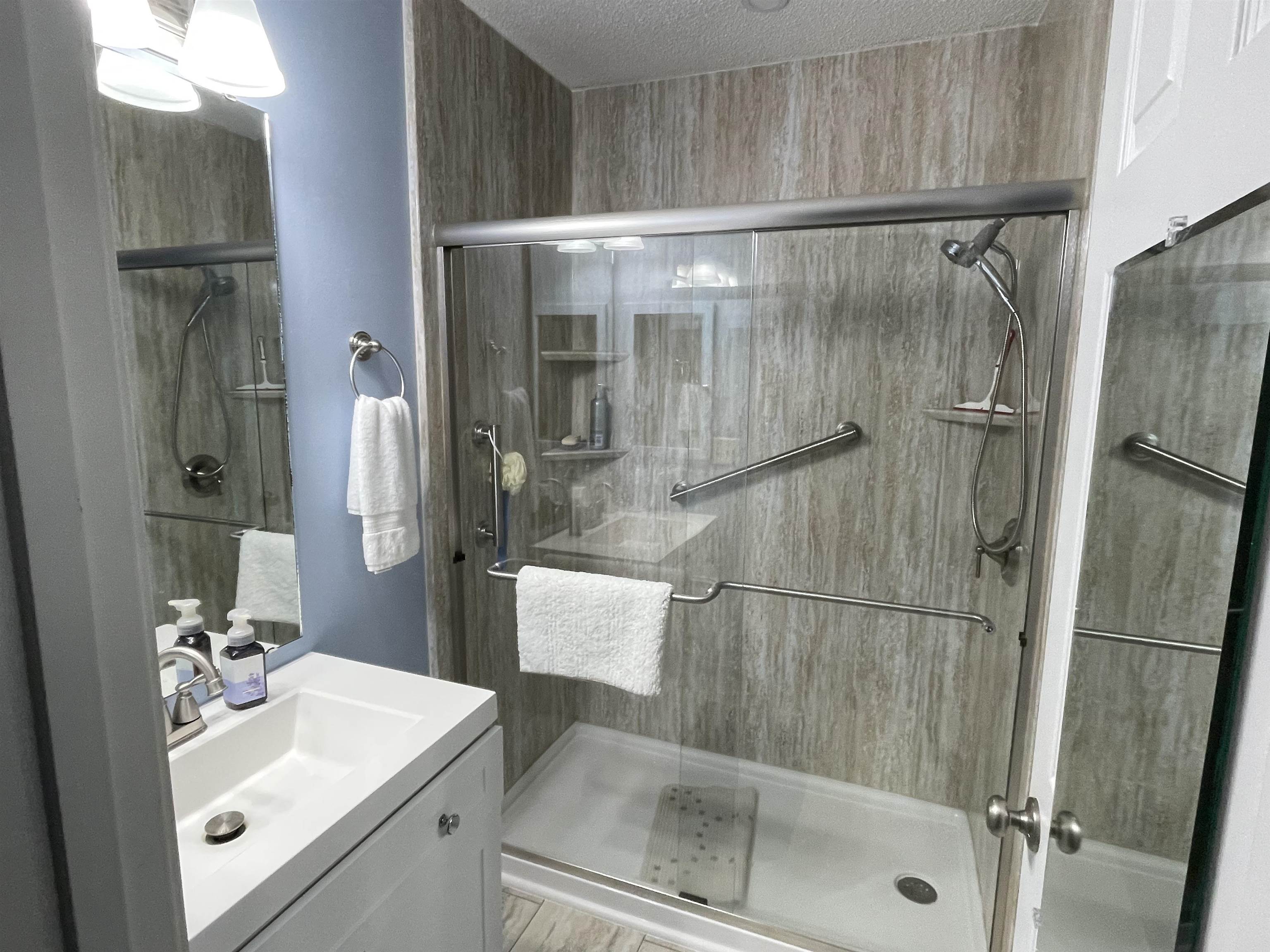 505 Night Heron Court Murrells Inlet, SC 29576 - Photo 14 of 27 Full bath with vanity, a stall shower, and a textured ceiling