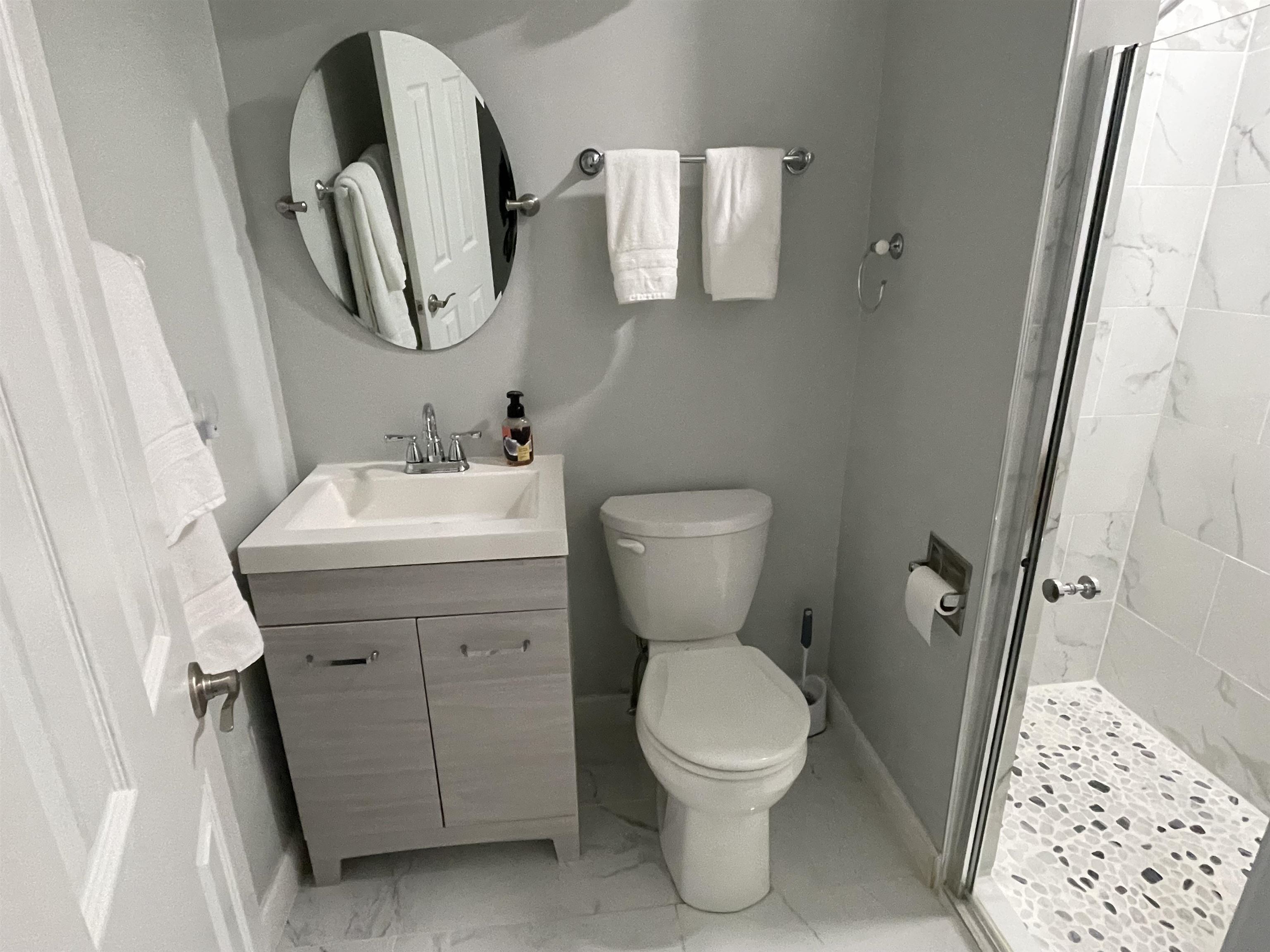 505 Night Heron Court Murrells Inlet, SC 29576 - Photo 22 of 27 Bathroom featuring a shower stall, vanity, and light marble finish floors