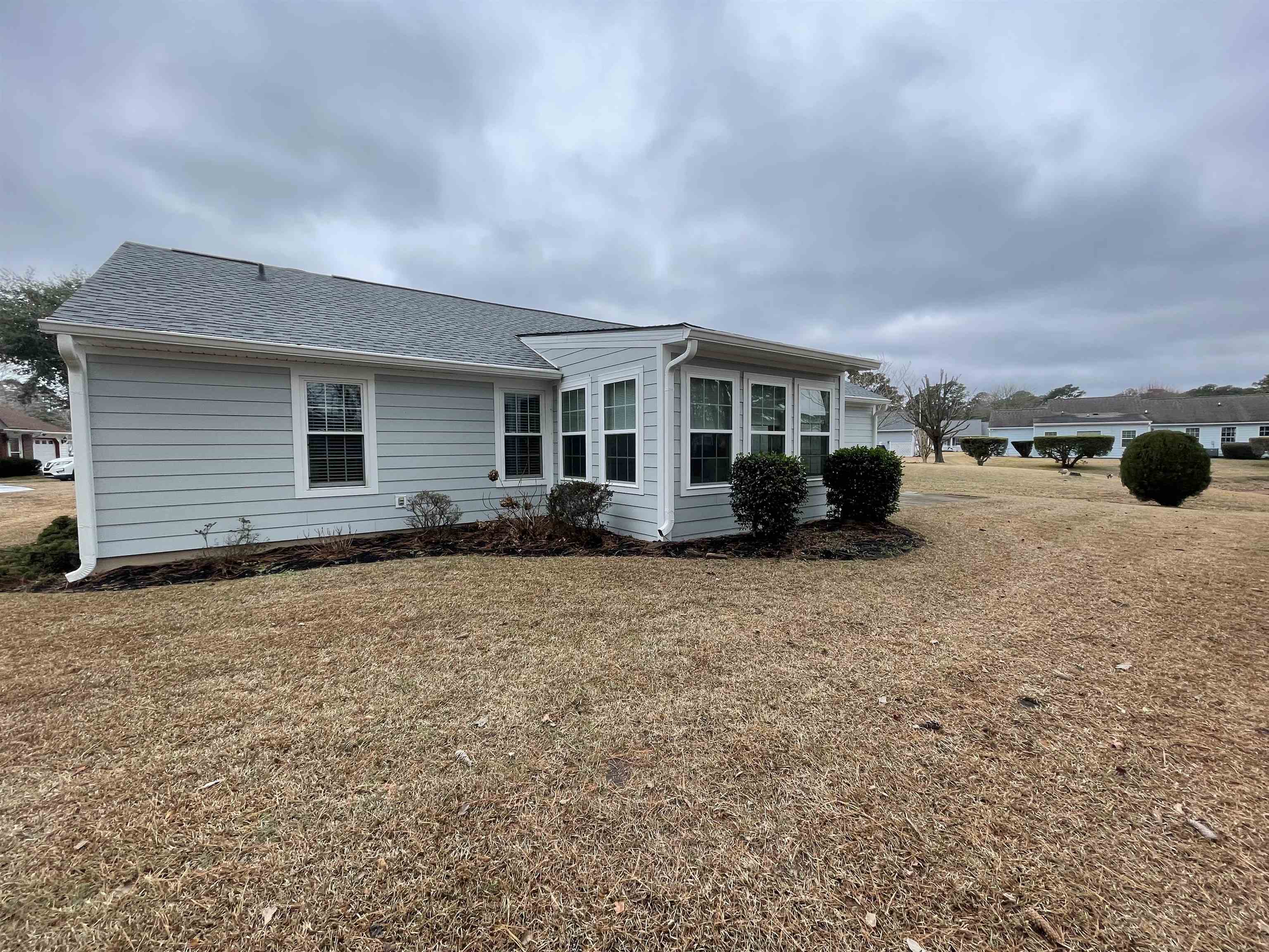 505 Night Heron Court Murrells Inlet, SC 29576 - Photo 26 of 27 View of property exterior with a shingled roof and a yard