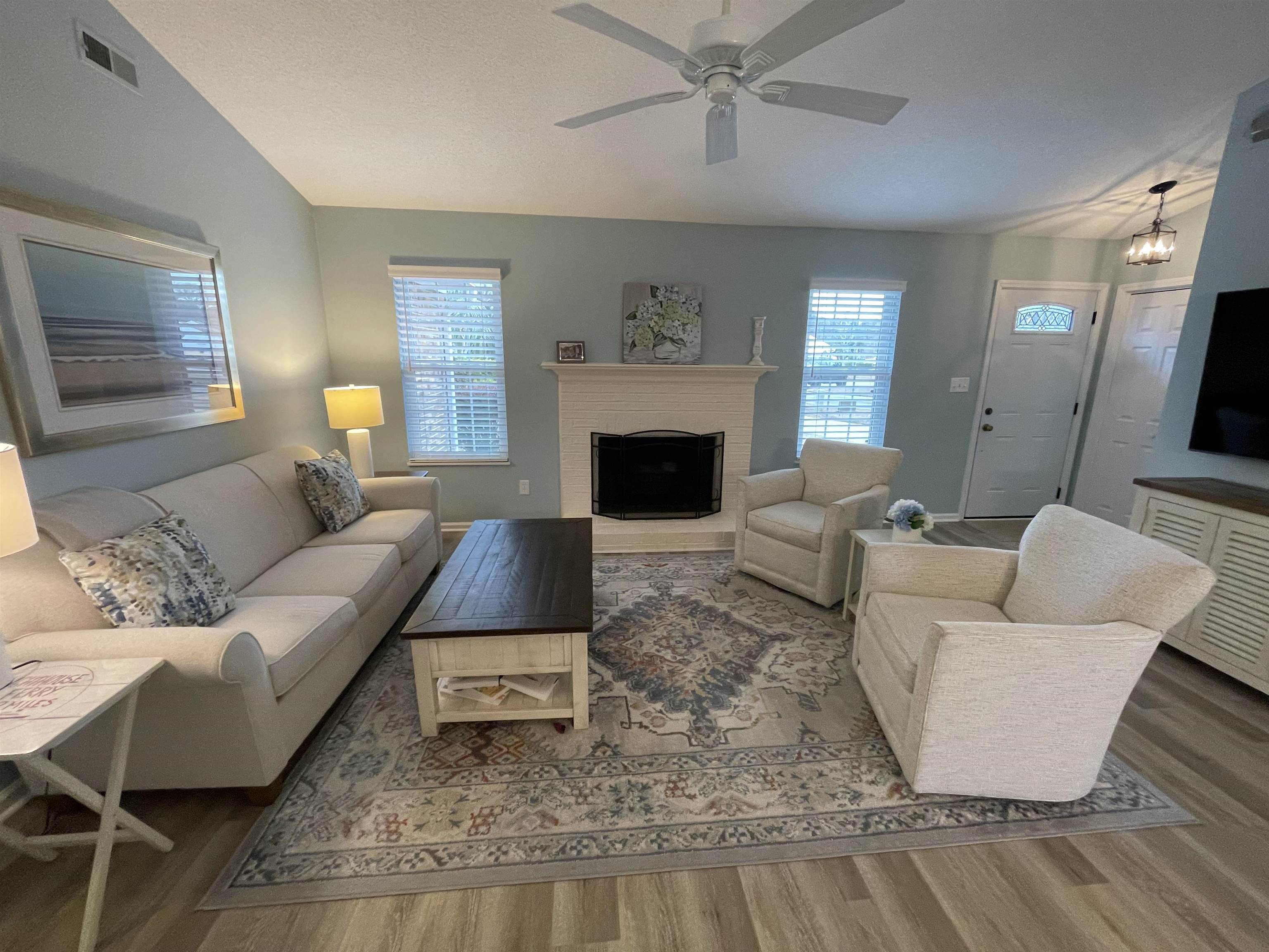 505 Night Heron Court Murrells Inlet, SC 29576 - Photo 3 of 27 Living area featuring light wood-type flooring, a fireplace, ceiling fan, and vaulted ceiling