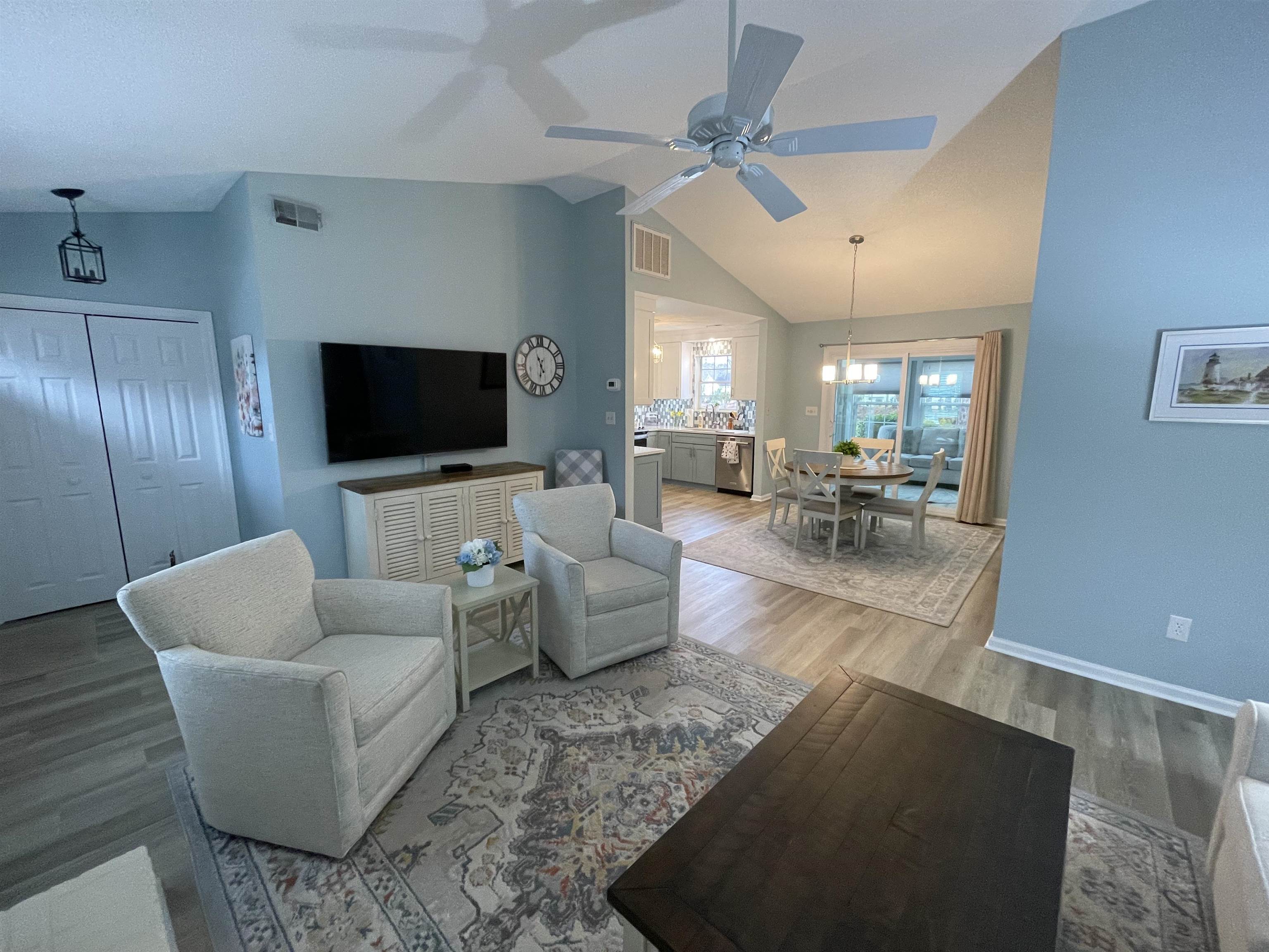 505 Night Heron Court Murrells Inlet, SC 29576 - Photo 4 of 27 Living room with wood finished floors, ceiling fan, high vaulted ceiling, and a chandelier