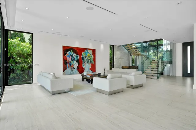 a living room with fireplace furniture and a large window