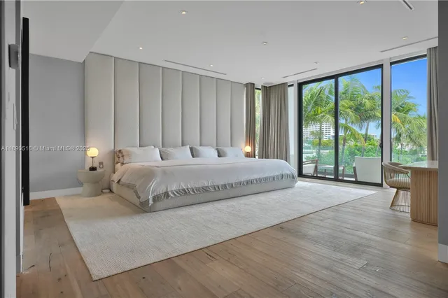 a bedroom with a large bed and a large window