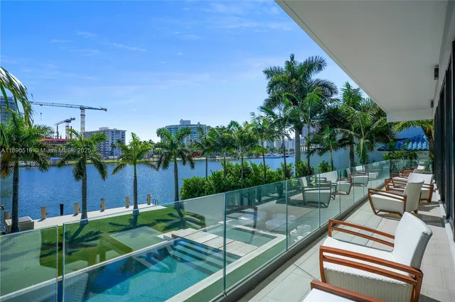 a view of a patio with chairs and a potted plant