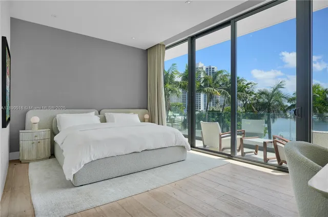 a bedroom with a large bed and a large window with outer view