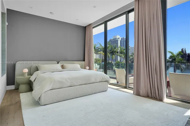 a bedroom with a large bed and a large window