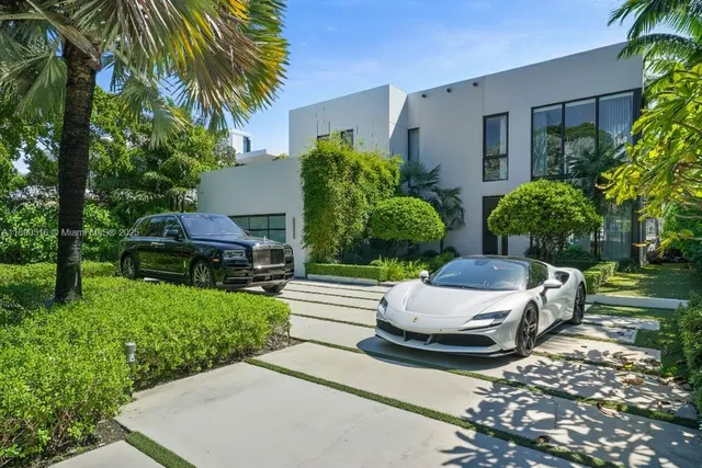 a white bench sitting in front of a house