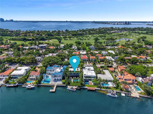 an aerial view of residential houses with outdoor space and swimming pool