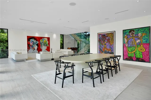 a view of a dining room with furniture a rug and a window