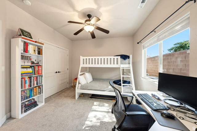 1609 East 10 S Street St. George, UT 84790 - Photo 35 of 68 Carpeted room featuring a ceiling fan with integrated lighting, a large window, and double bi-fold doors