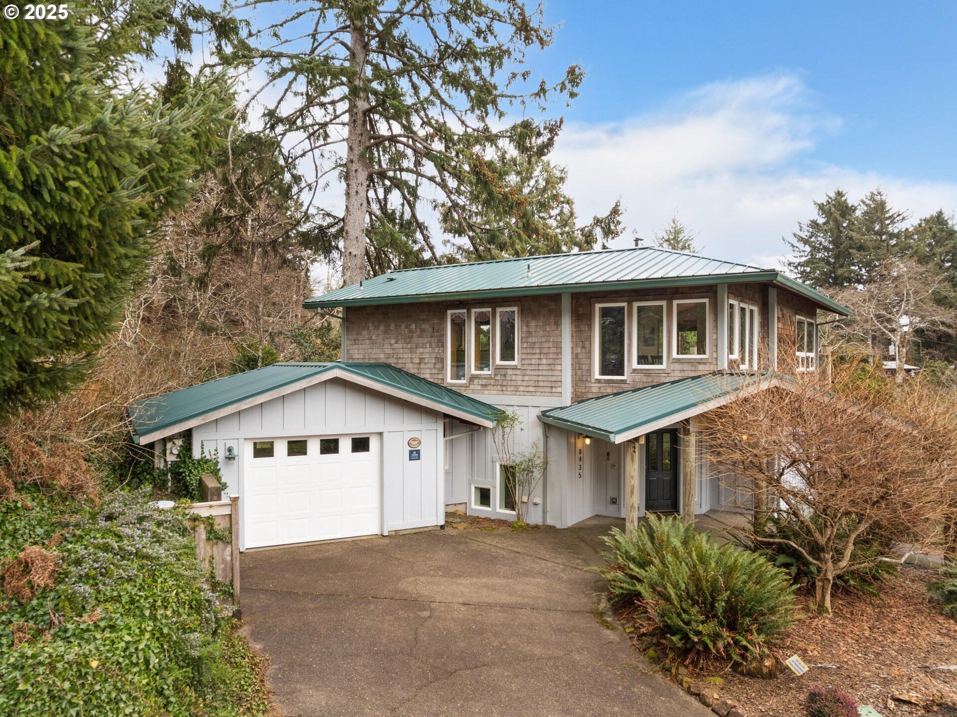 8435 Treasure Rocks Road Nehalem, OR 97131 - Photo 1 of 41 a front view of a house with a yard and trees