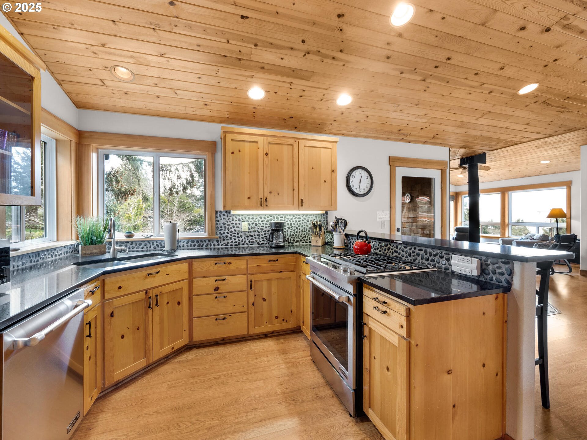 8435 Treasure Rocks Road Nehalem, OR 97131 - Photo 11 of 41 a kitchen with stainless steel appliances granite countertop a stove and a sink