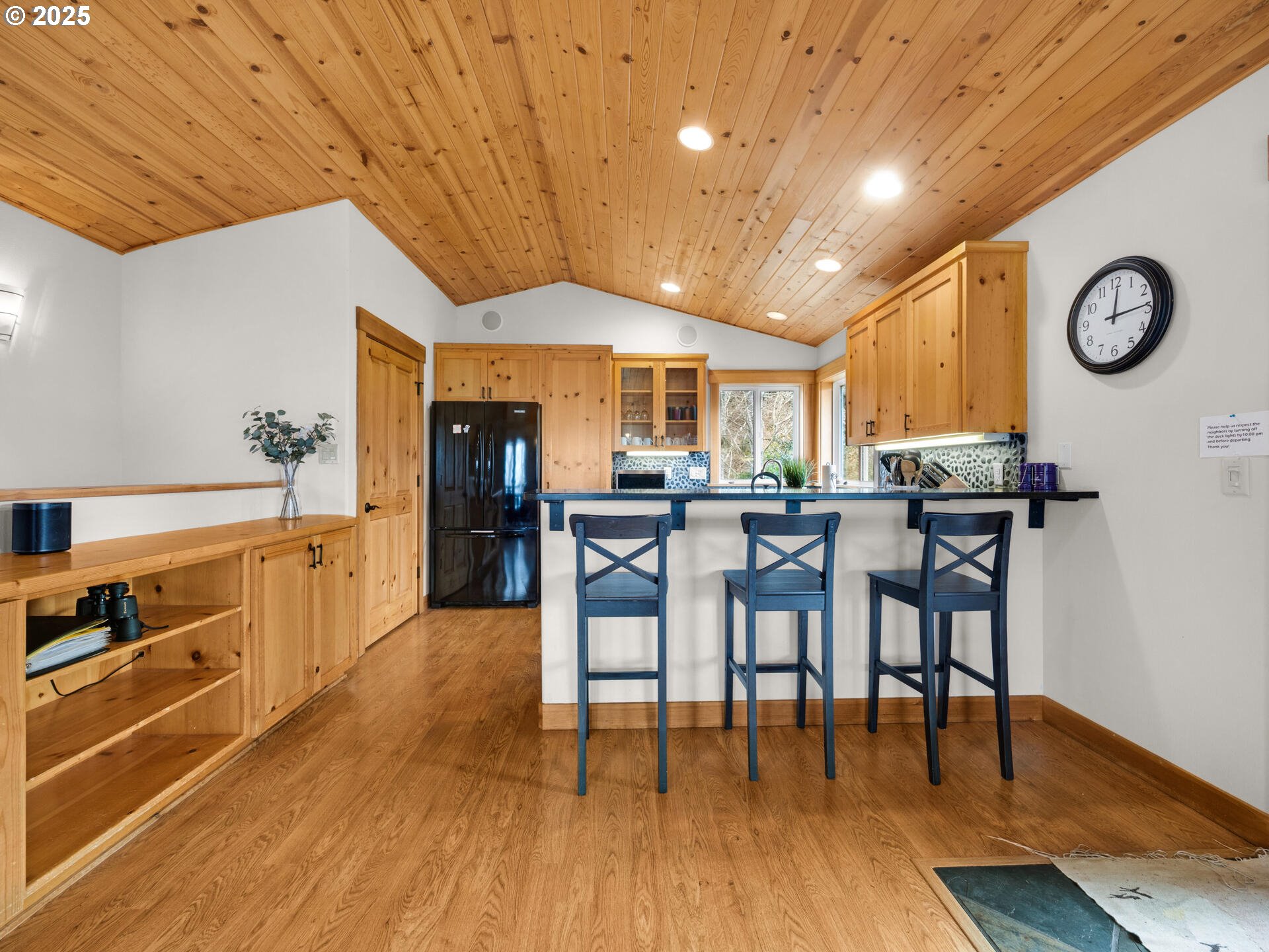 8435 Treasure Rocks Road Nehalem, OR 97131 - Photo 13 of 41 a kitchen with stainless steel appliances granite countertop a table chairs and a stove