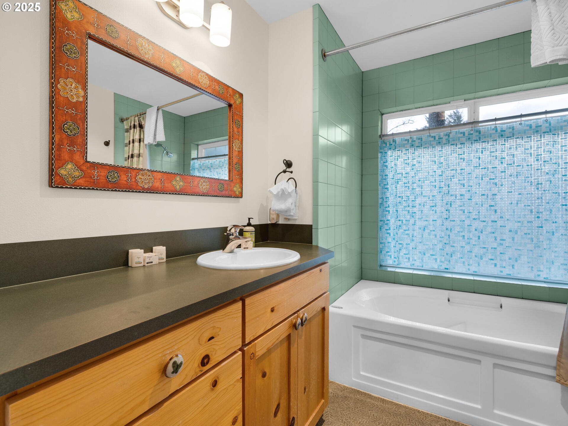 8435 Treasure Rocks Road Nehalem, OR 97131 - Photo 31 of 41 a bathroom with a granite countertop sink mirror and a bathtub