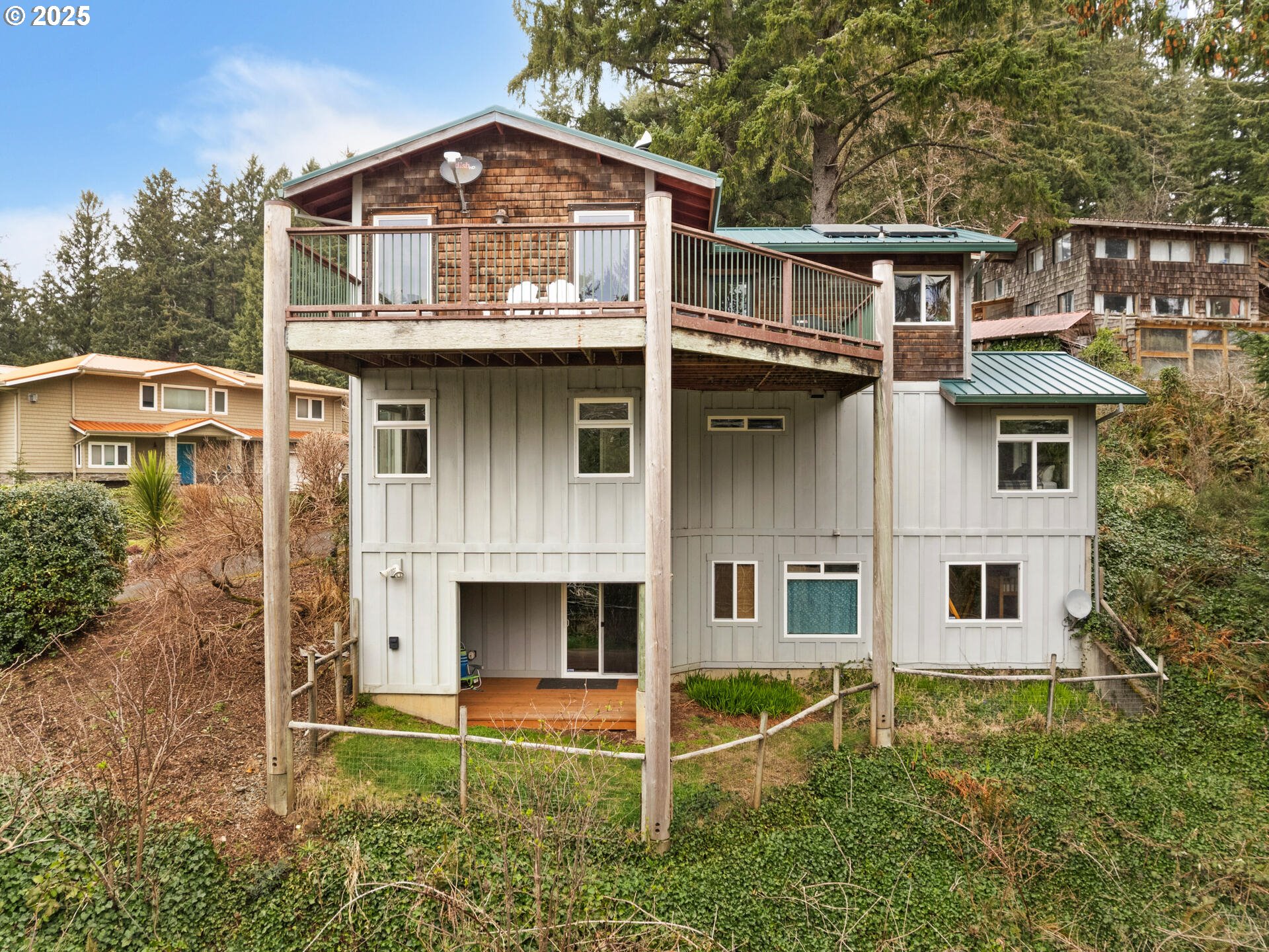 8435 Treasure Rocks Road Nehalem, OR 97131 - Photo 5 of 41 a front view of a house with a yard