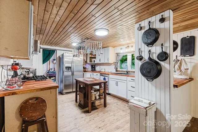 a kitchen with granite countertop a sink a stove and cabinets