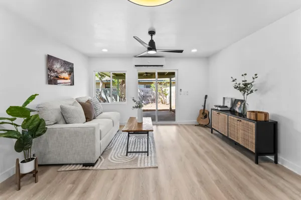 a living room with furniture and a wooden floor