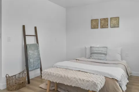 a bedroom with a bed and a chair