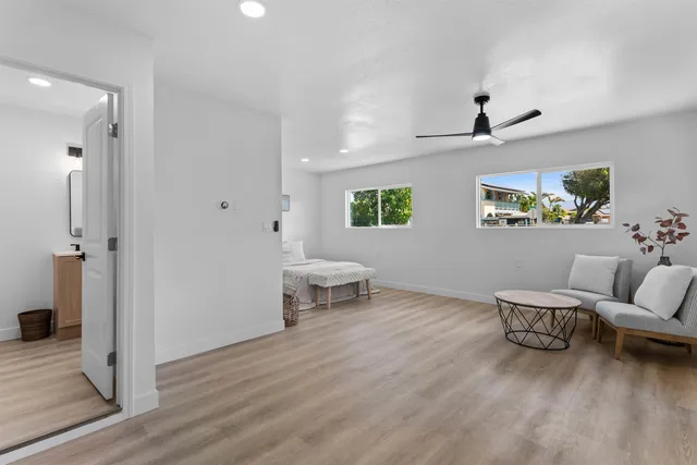 a living room with furniture and a wooden floor