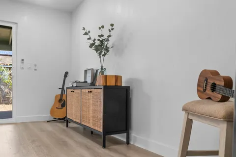 a room with a window and potted plant